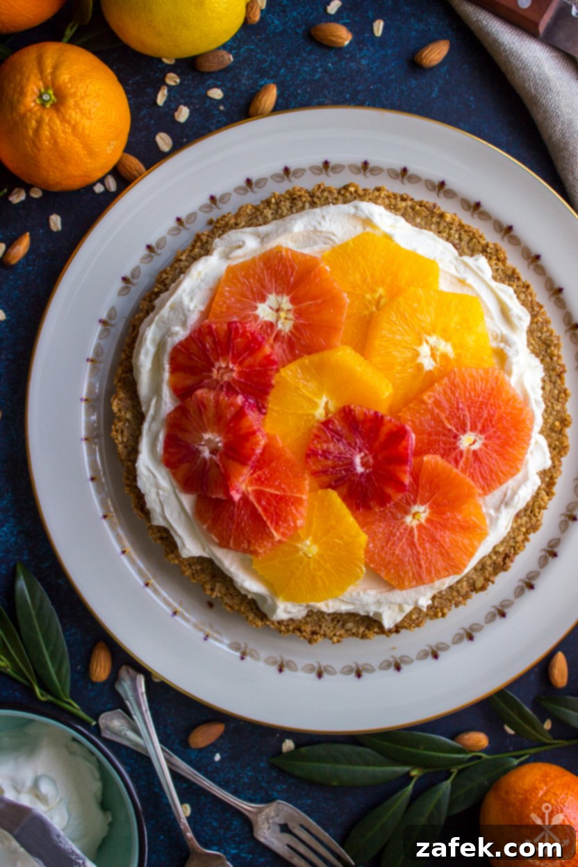 Overhead close-up of a freshly made orange tart, showcasing its vibrant citrus topping