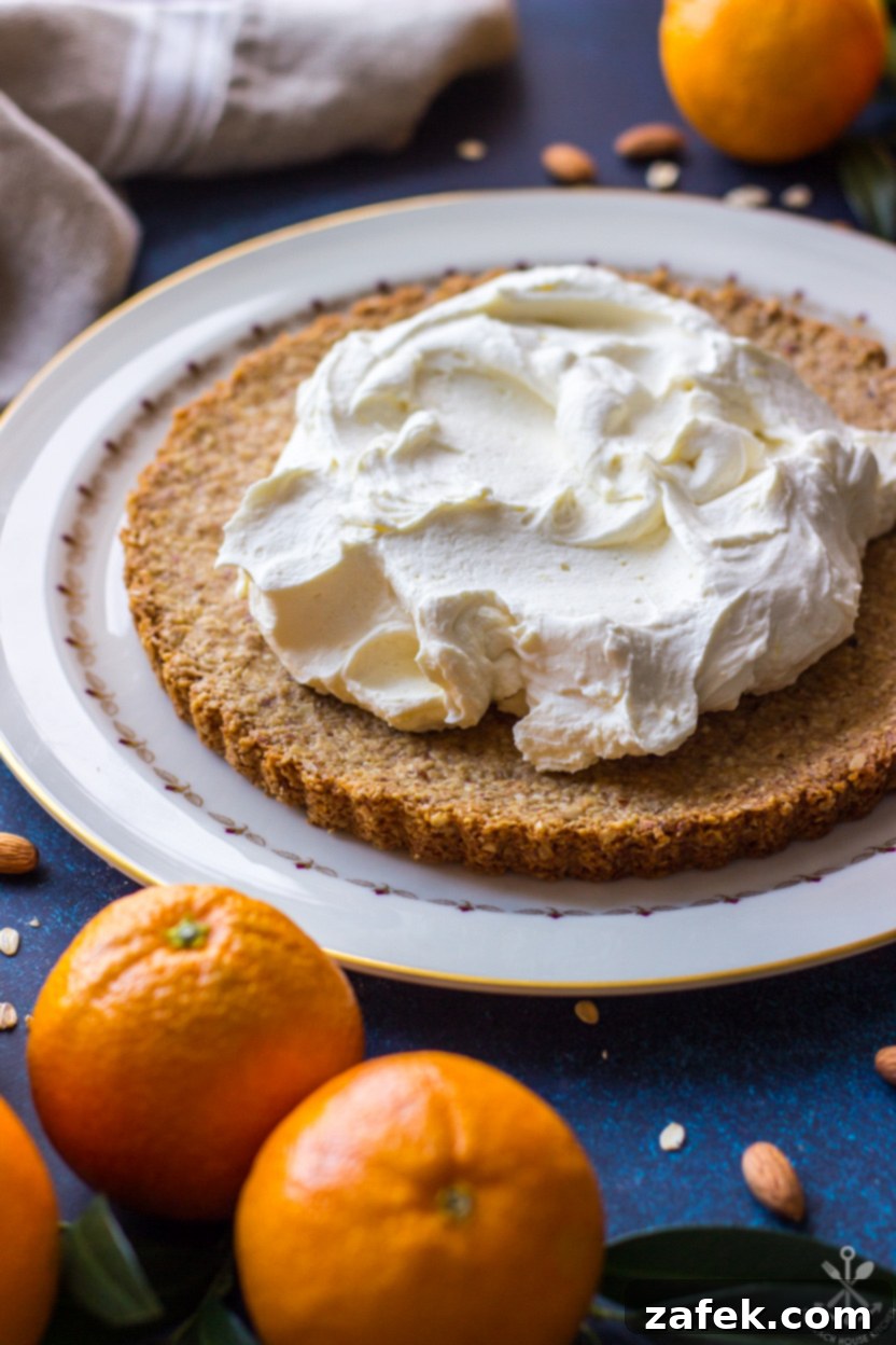 Close-up photo of a baked tart crust generously filled with smooth, white mascarpone cream