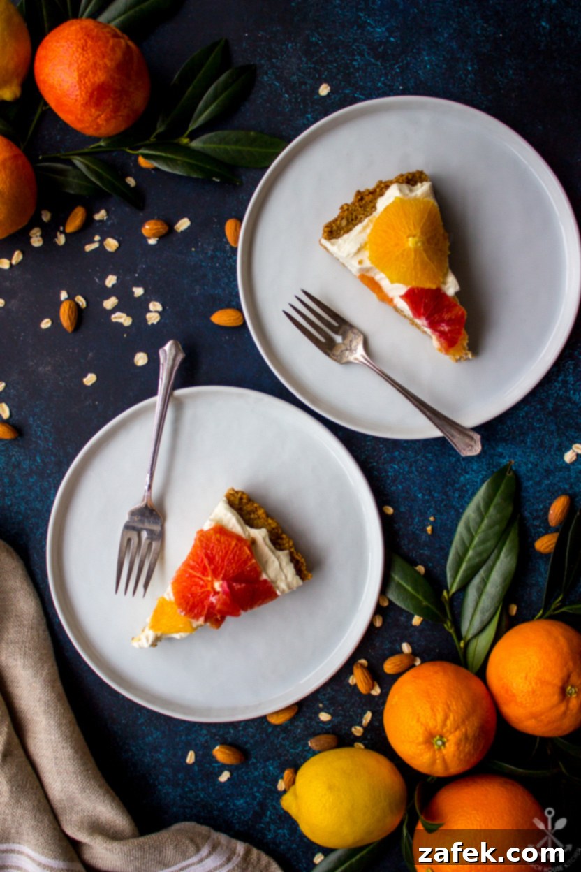 Overhead shot of several slices of a citrus tart arranged on white plates
