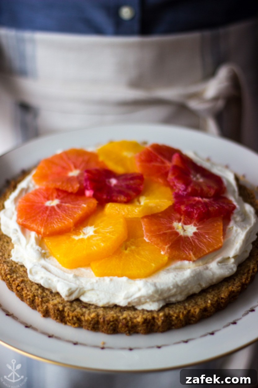 Close-up photo of a winter citrus tart, featuring beautifully arranged orange slices on top