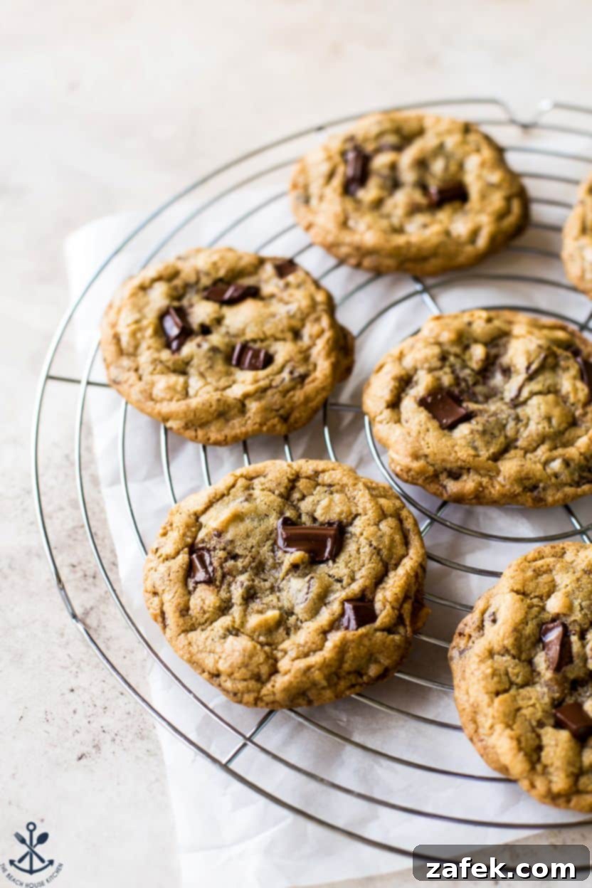 Coconut Almond Chocolate Chip Bliss Cookies 2 Almond Joy Chocolate Chip Cookies on a round wire rack