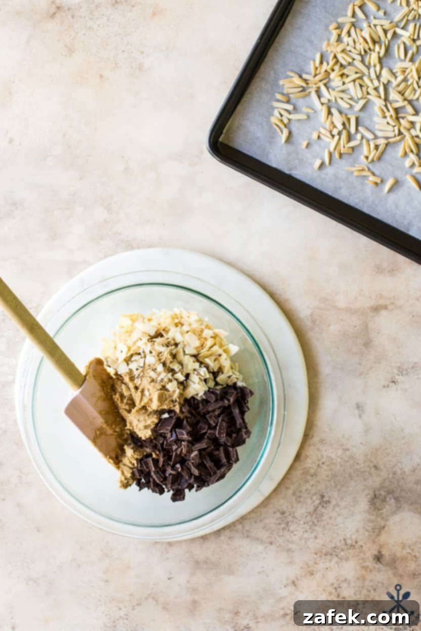Coconut Almond Chocolate Chip Bliss Cookies 5 Overhead photo of a bowl filled with cookie dough, coconut and chocolate chunks