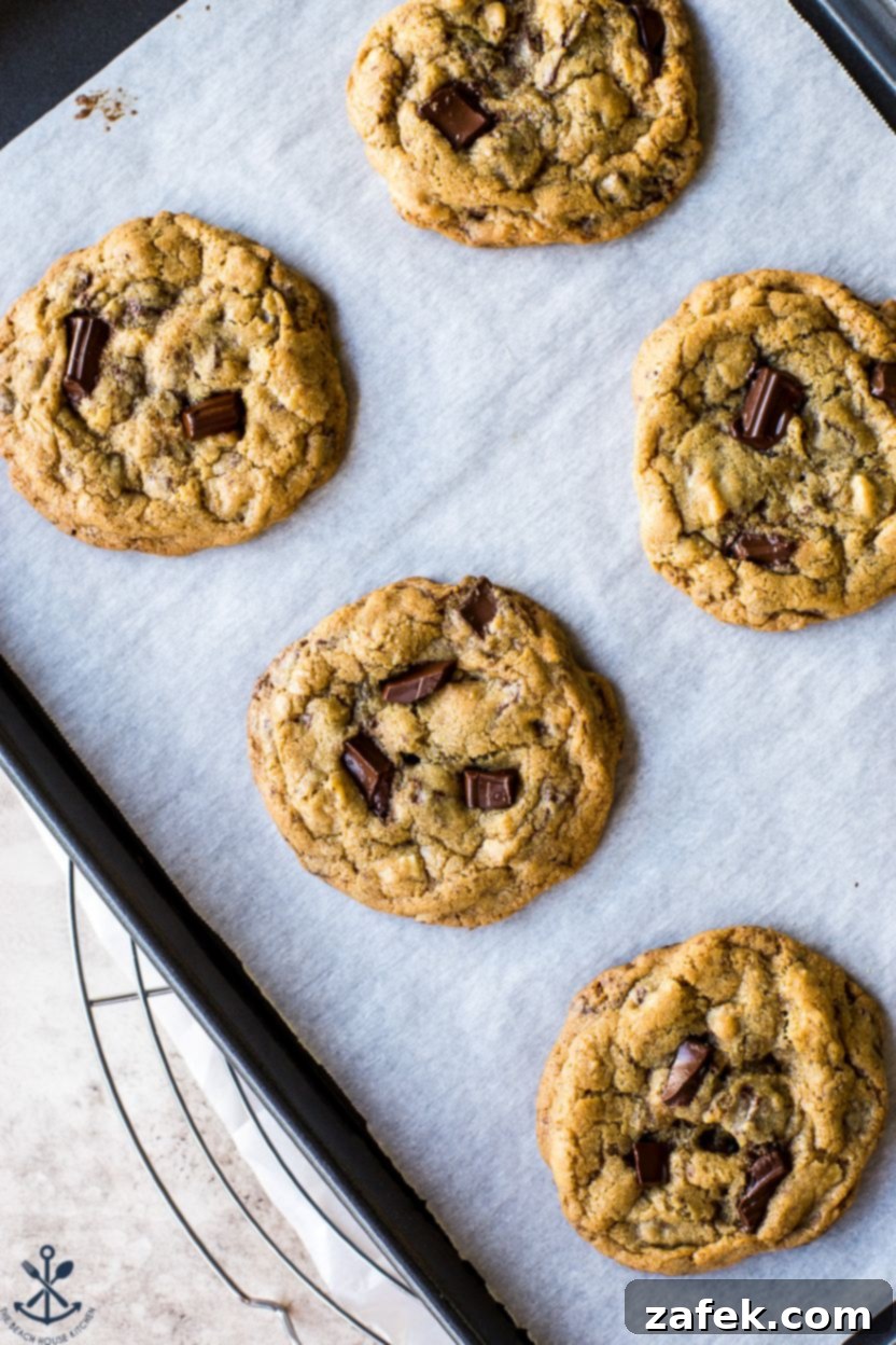 Coconut Almond Chocolate Chip Bliss Cookies 7 Overhead photo of chocolate chip cookies on a parchment-lined baking sheet