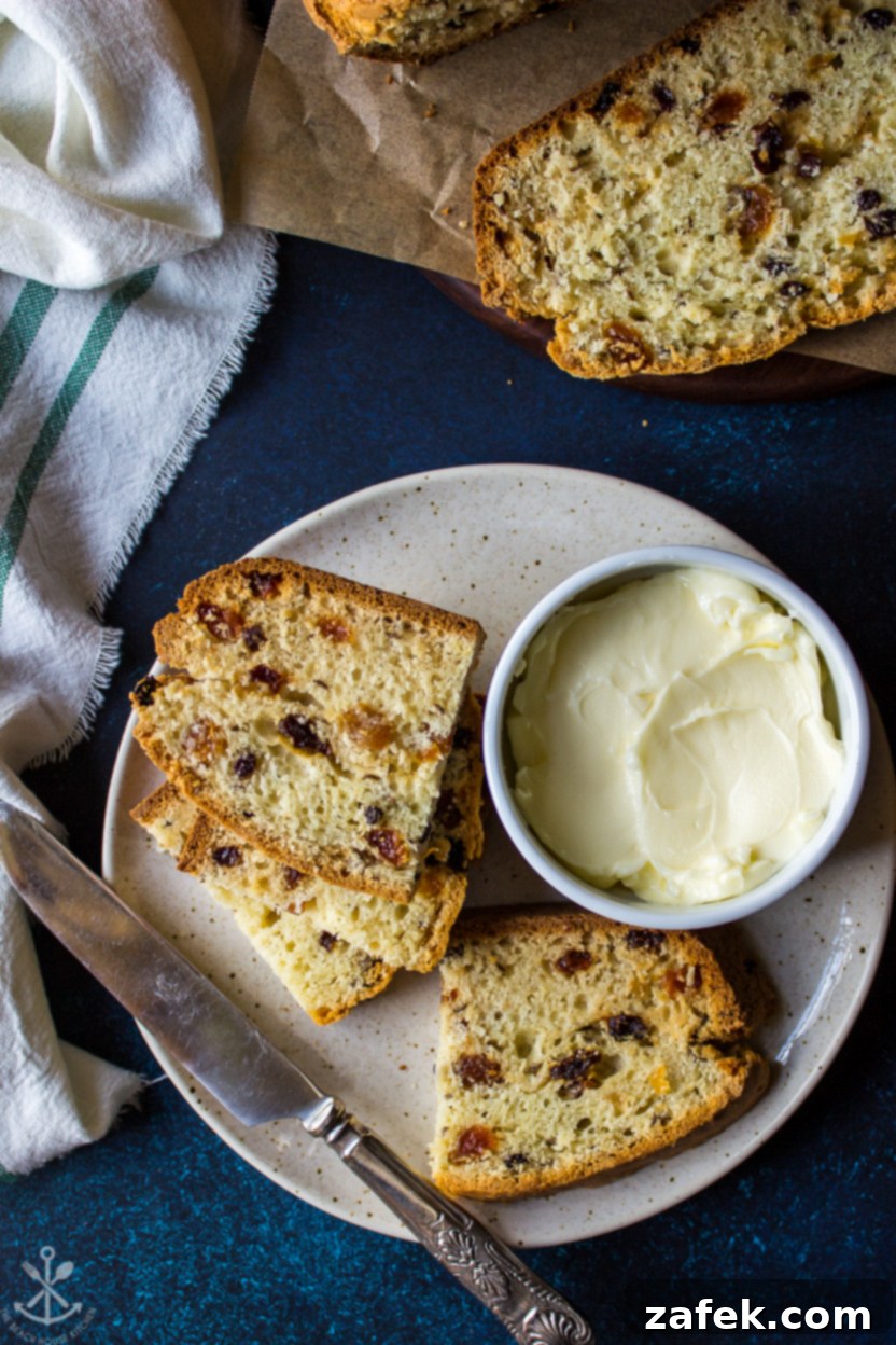 Overhead photo of slices of Irish Soda Bread on a plate with a knife and a bowl of butter