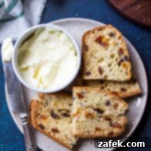 Overhead photo of plate with slices of Irish Soda Bread, butter in a small round dish and a silver knife.