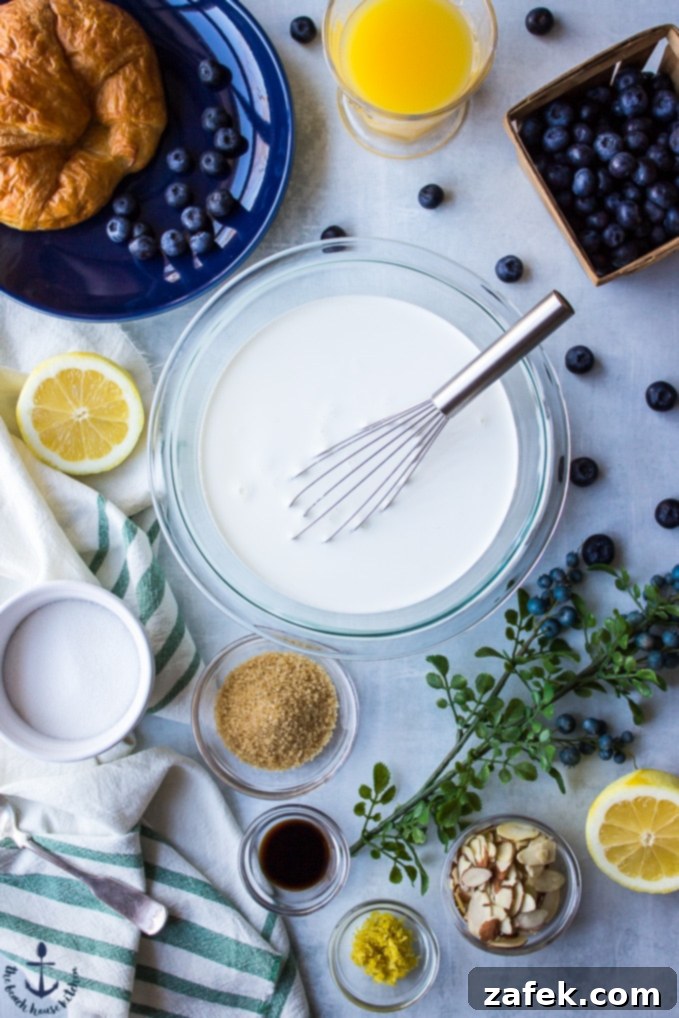 Blueberry Croissant Bread Pudding with Blueberry Sauce Overhead view of various ingredients for Blueberry Croissant Bread Pudding laid out in individual white bowls: blueberries, torn croissants, eggs, sugar, and lemon.
