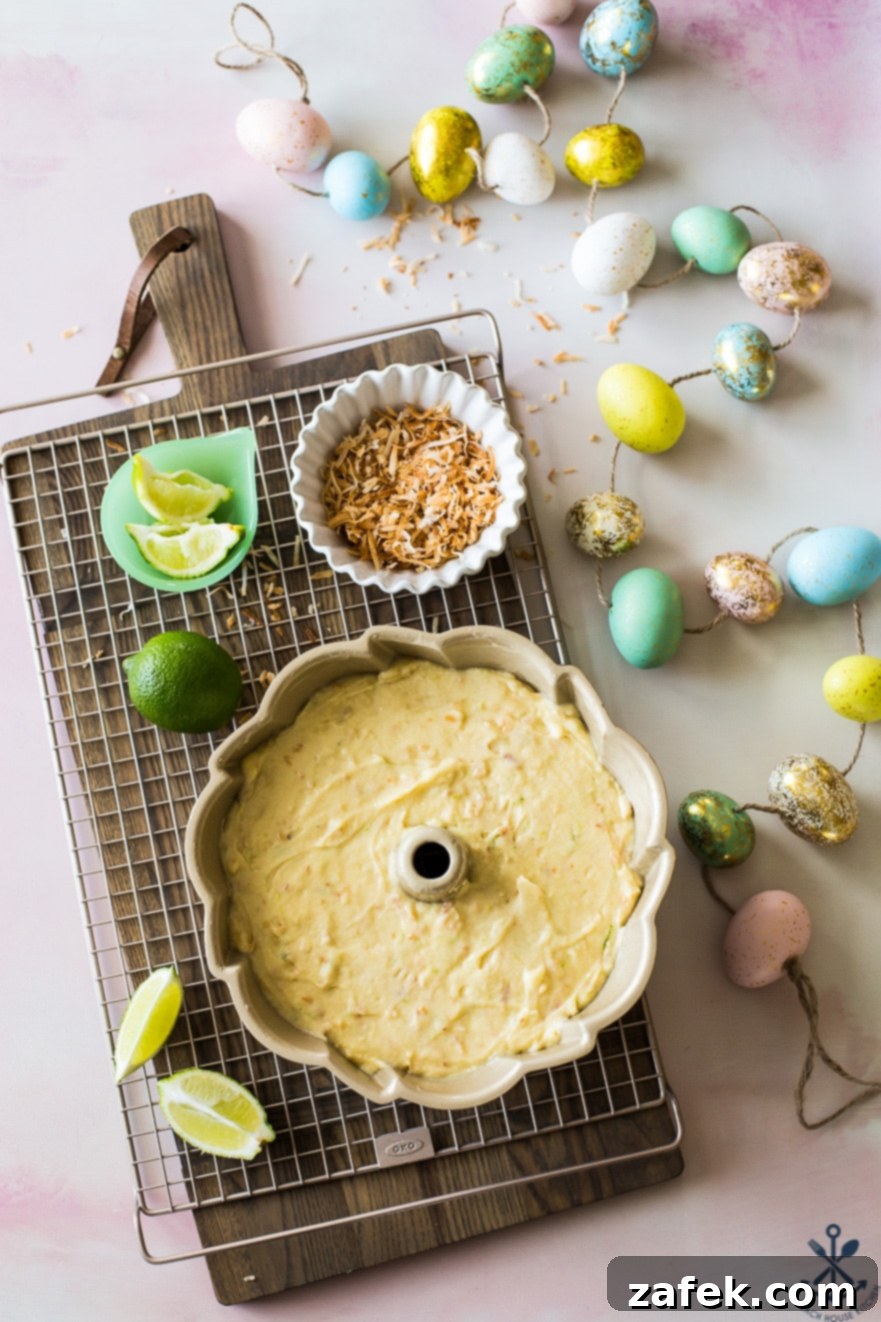 Overhead photo of pre-baked bundt cake in bundt pan on a wire rack with easter eggs on the side 