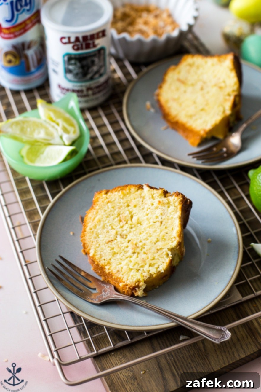 A slice of key lime bundt cake on a blue plate with a metal fork on the side