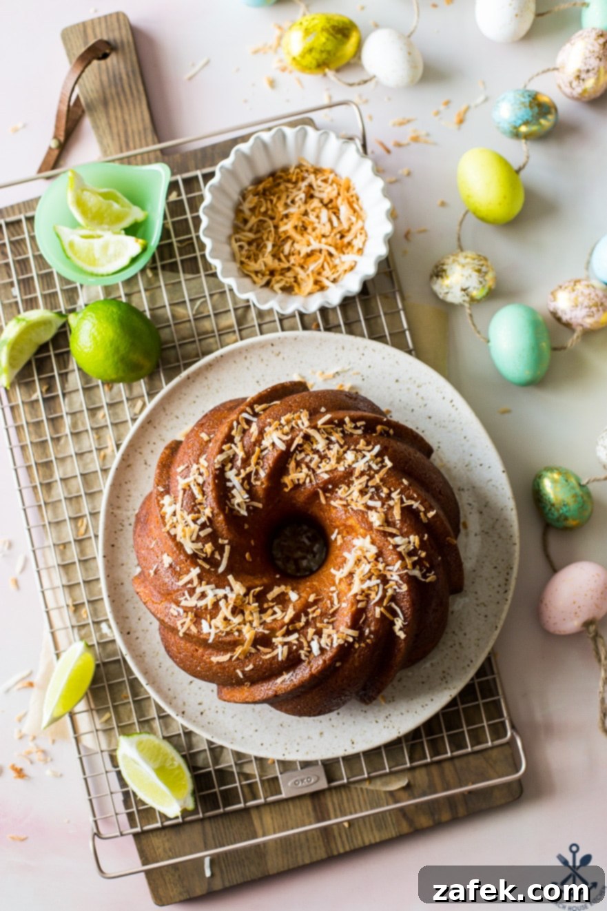 Overehad photo of a bundt cake on a plate on a gold wire rack with plenty of Easter eggs around the rack