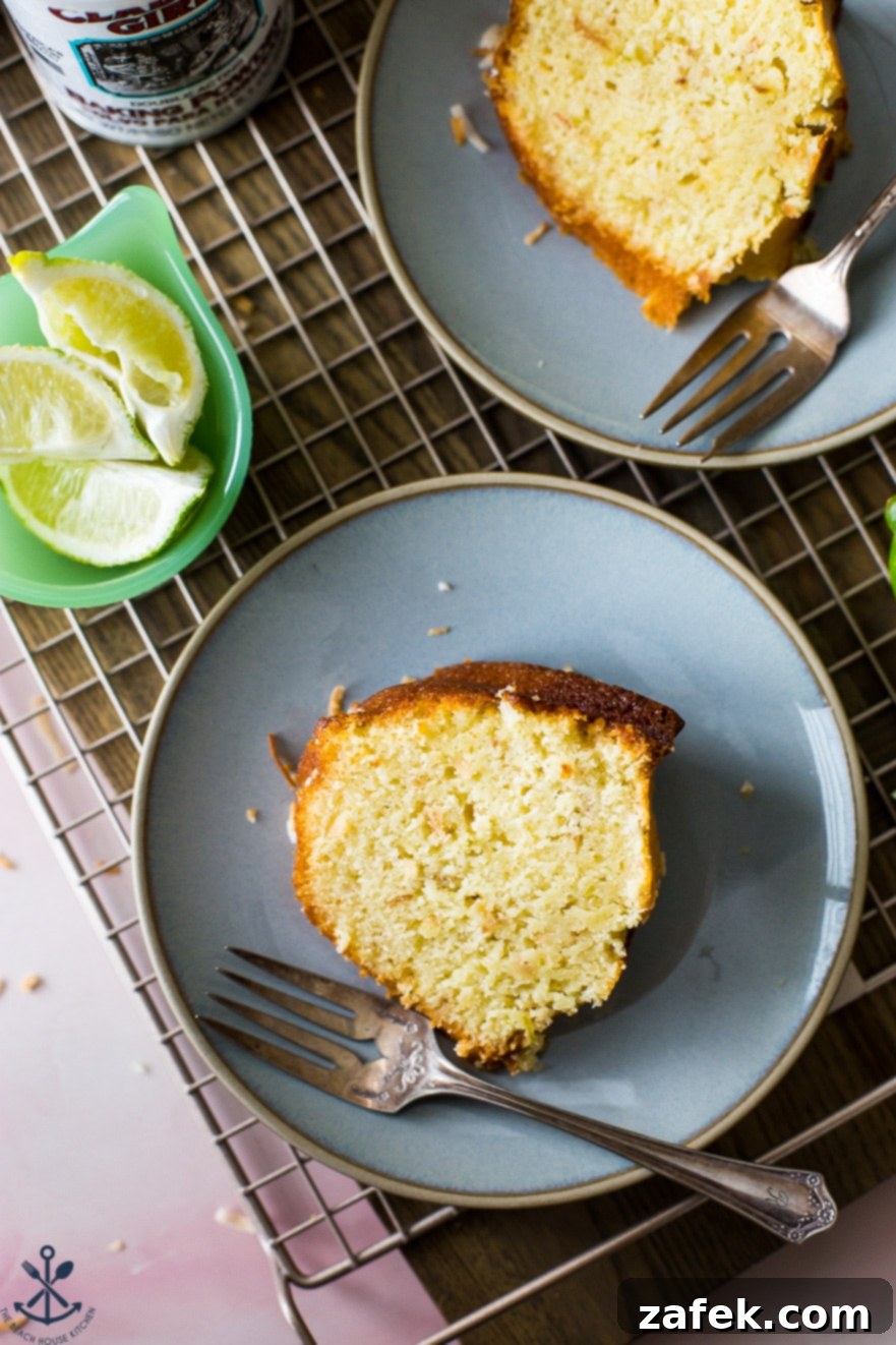 Up close overhead photo of a slice of bundt cake on a blue plate with a metal fork on the side