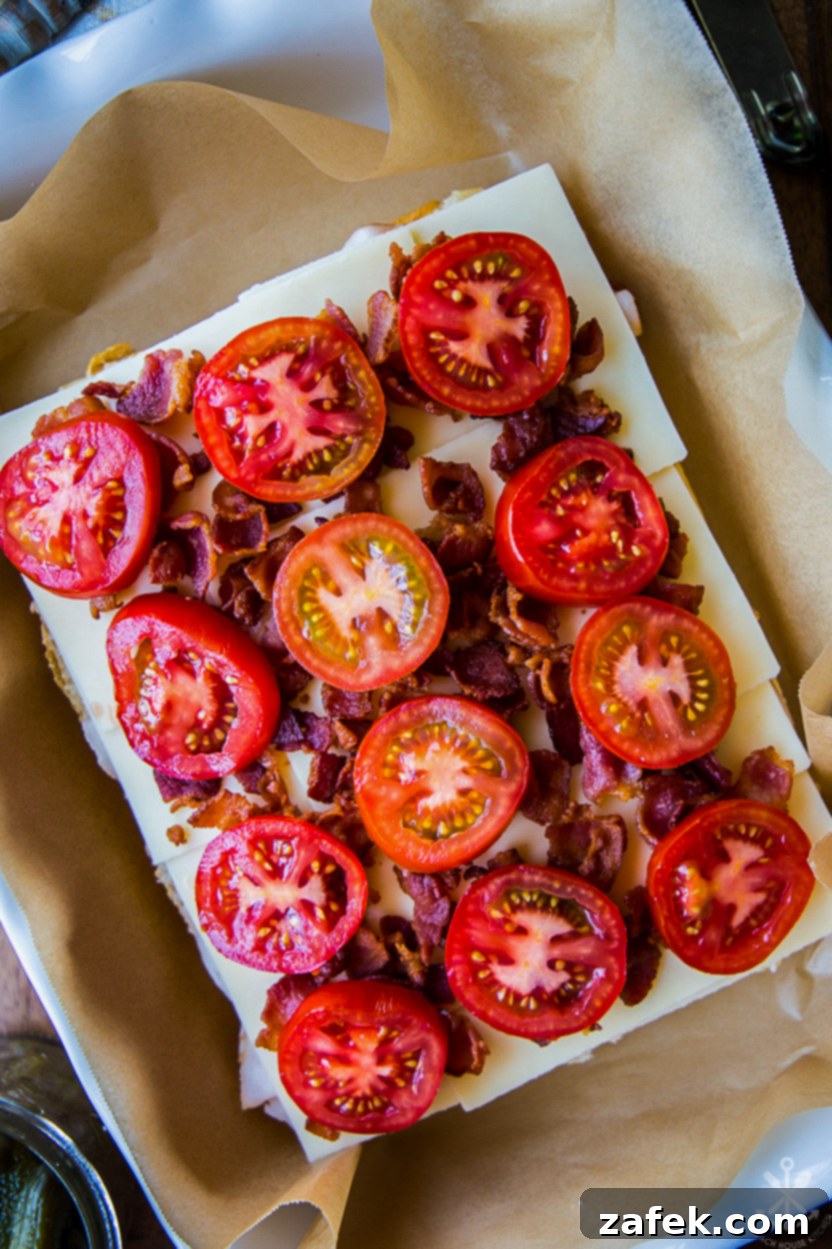 Southern Hot Brown Bites 5 Overhead photo of tomato and bacon topped pre-baked slider sandwiches