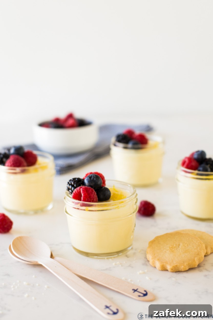 Lemon posset in glass jars topped with berries