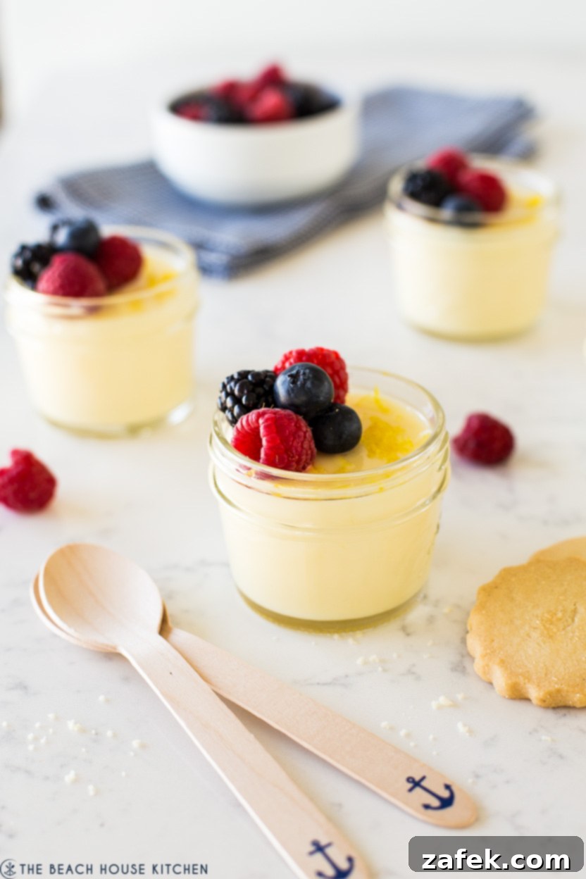 Up close photo of jar filled with lemon posset topped with berries