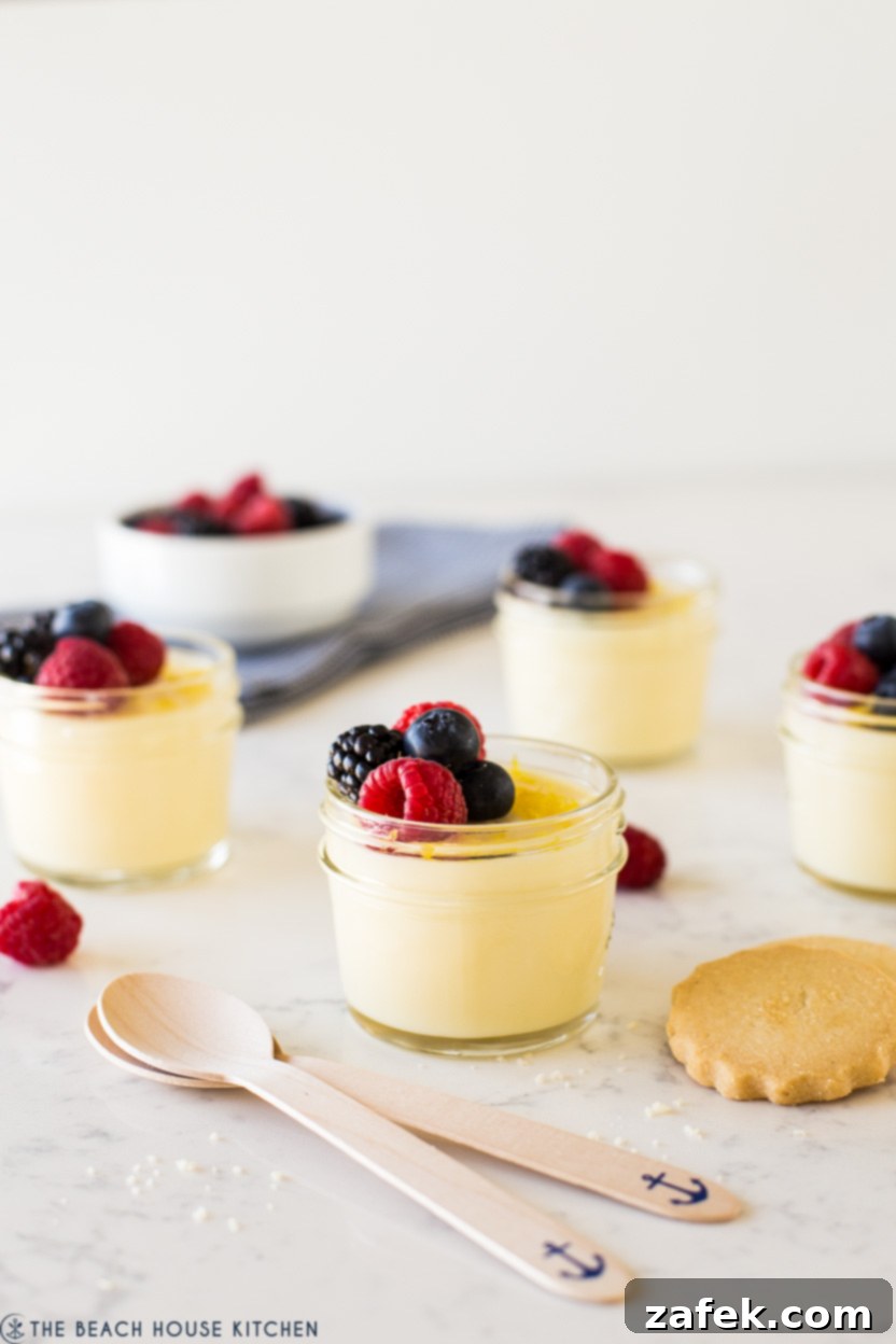 Jars of lemon posset topped with fresh berries