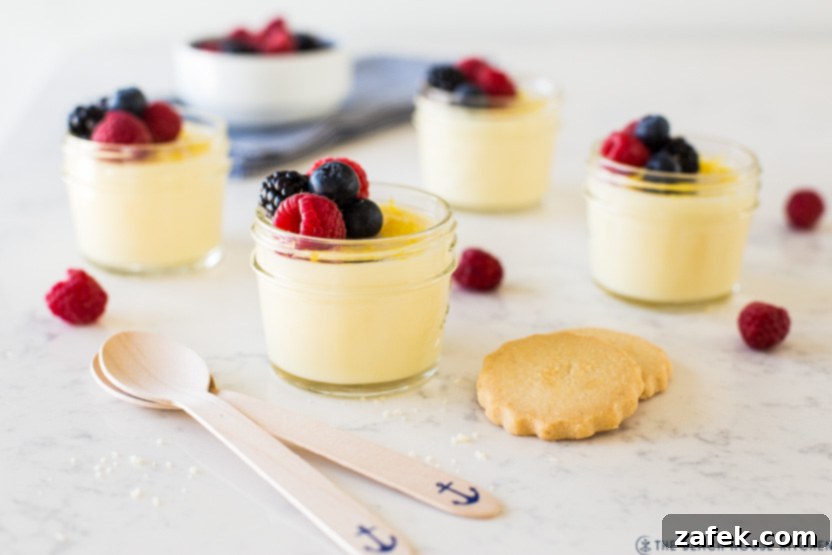 Jars filled with a lemon pudding topped with berries