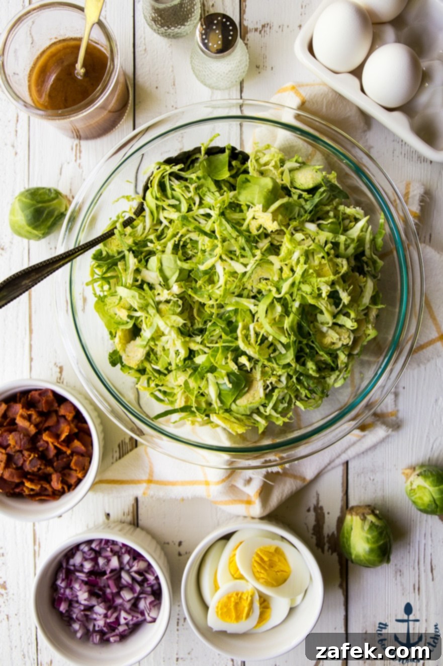 Shaved Brussels Sprouts Salad with Warm Bacon Dressing Close-up of Shaved Brussels Sprouts Salad with crispy bacon bits, sliced hard-boiled eggs, and caramelized red onion.