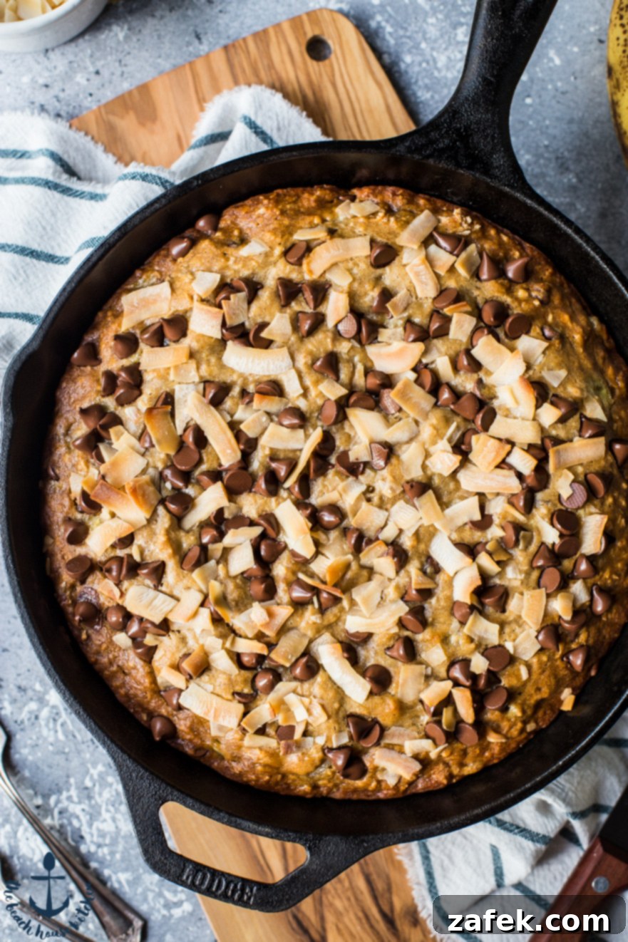 Coconut Chocolate Chip Skillet Banana Bread A close-up, overhead shot revealing the moist texture of Coconut Chocolate Chip Skillet Banana Bread, with melted chocolate and flecks of coconut.