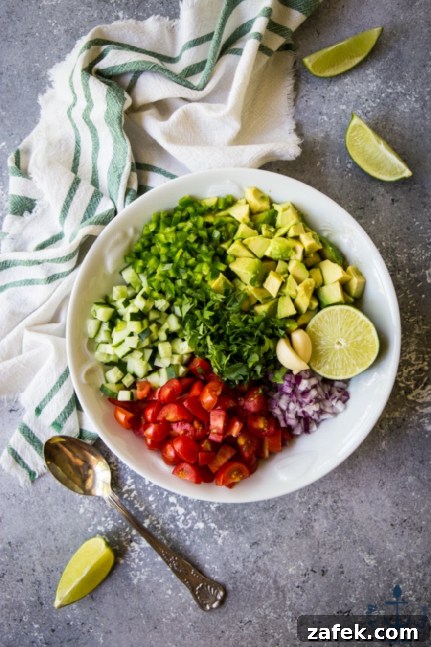 Avocado and Tomato Salsa Bowl of Avocado and Tomato Salsa with a spoon, ready to be enjoyed