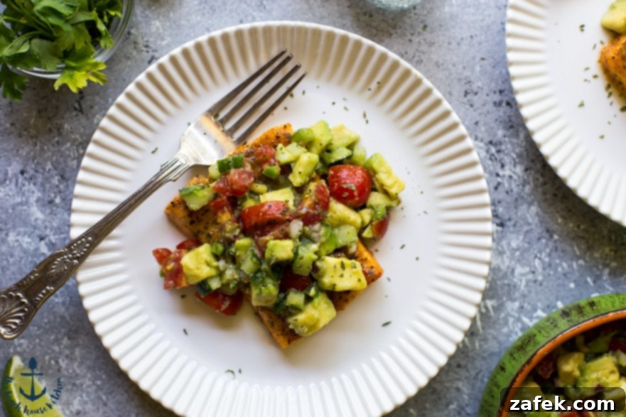 Avocado and Tomato Salsa Blackened Salmon with Avocado Salsa served on a plate