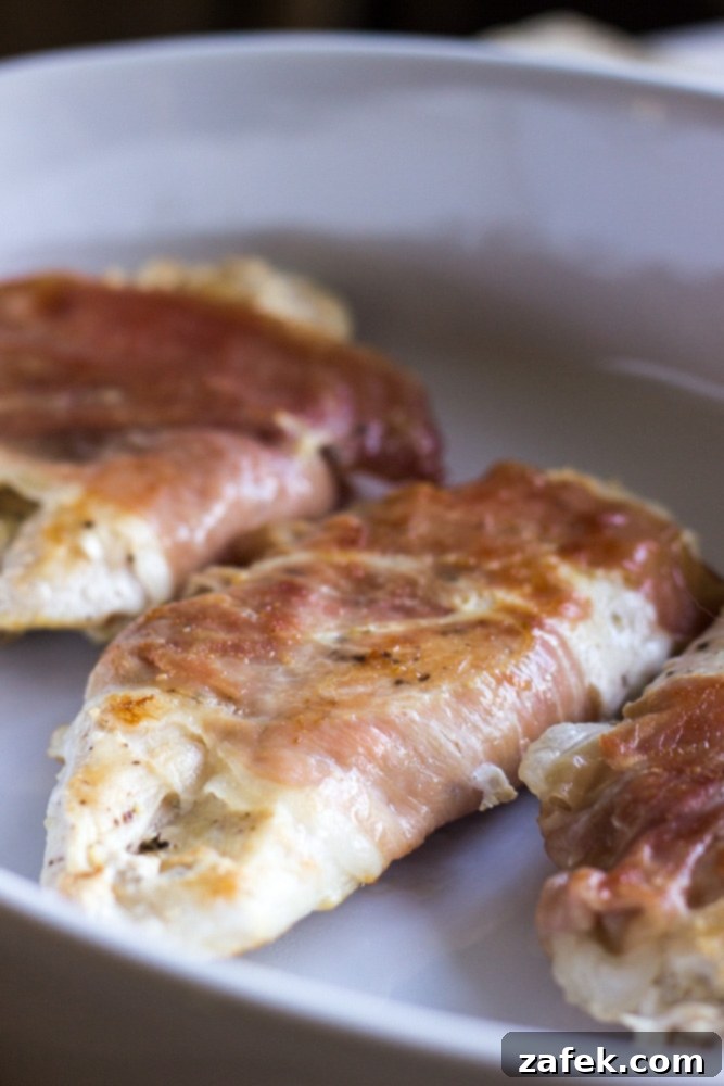 Prosciutto-Wrapped Chicken Paillards with Creamy Fontina and Fresh Sage 3 Close-up of Prosciutto Wrapped Chicken Paillards, showcasing the golden crust and melted fontina cheese.