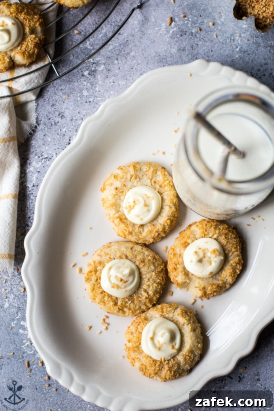 Creamy Coconut Thumbprint Bites 7 Overhead photo of a plate of coconut cookies and a bottle of milk