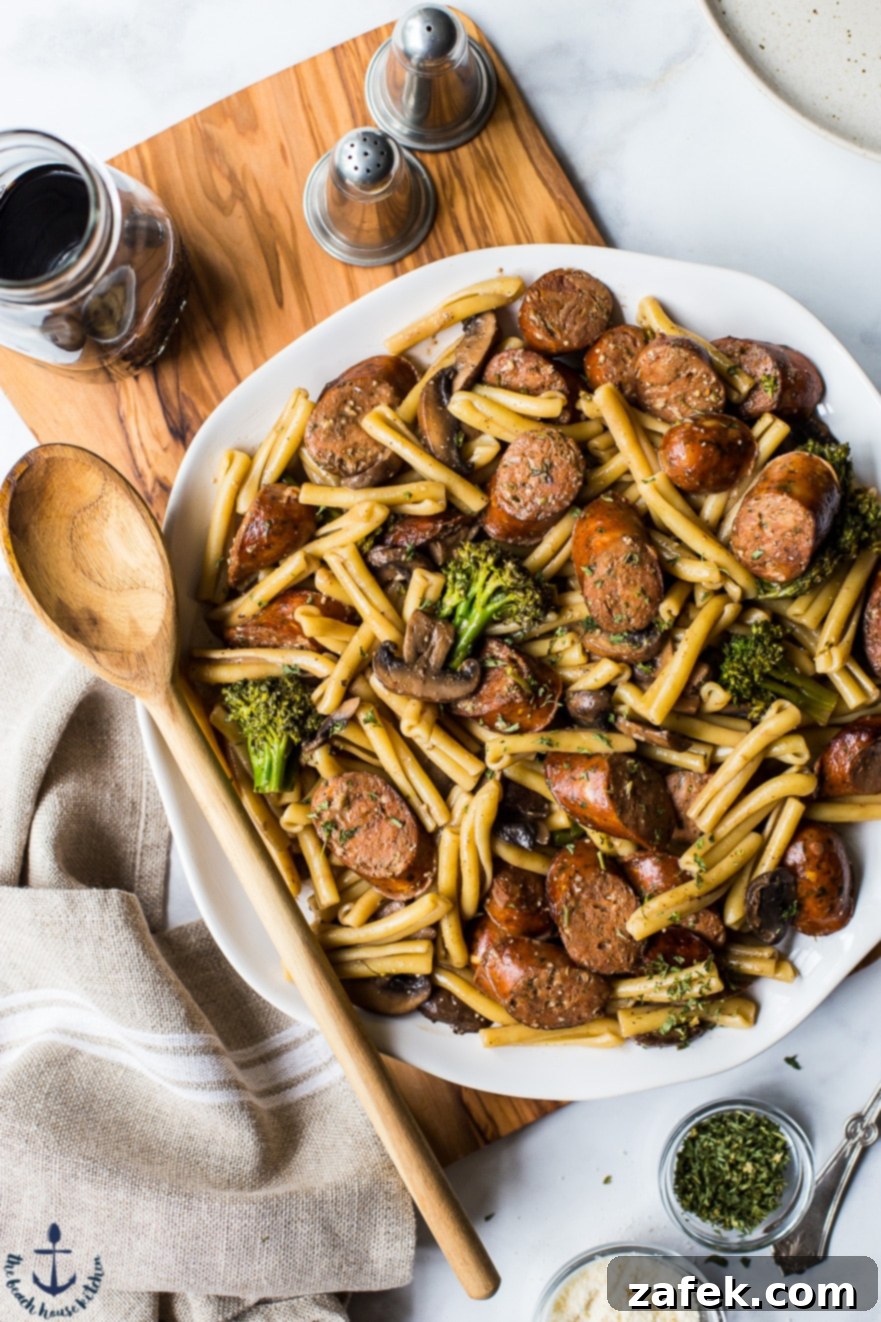 Overhead photo of a platter of Balsamic Pasta with Chicken Sausage, Broccoli and Mushrooms, showcasing vibrant colors and enticing textures.
