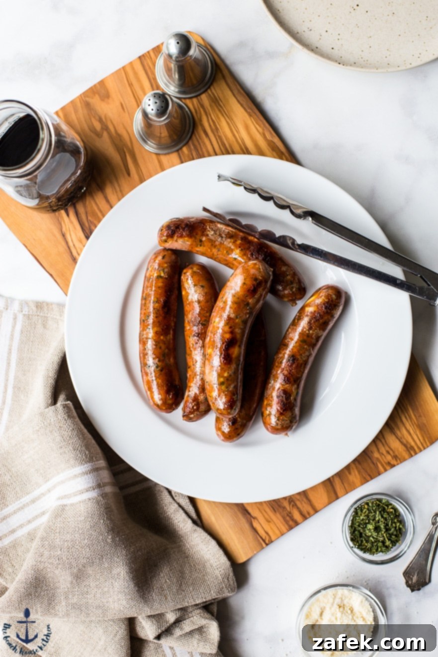 Overhead photo of perfectly cooked chicken sausage, lightly browned and ready to be sliced, highlighting its appealing texture.