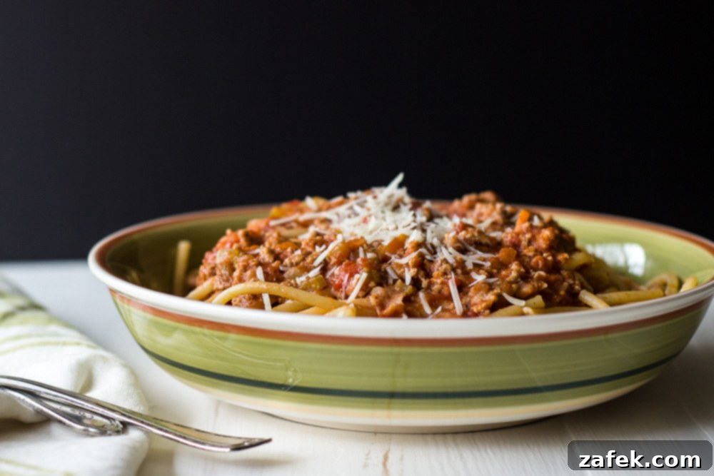 Ingredients for Bucatini Bolognese laid out on a cutting board