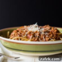 Bucatini Bolognese with sauce and Parmesan cheese