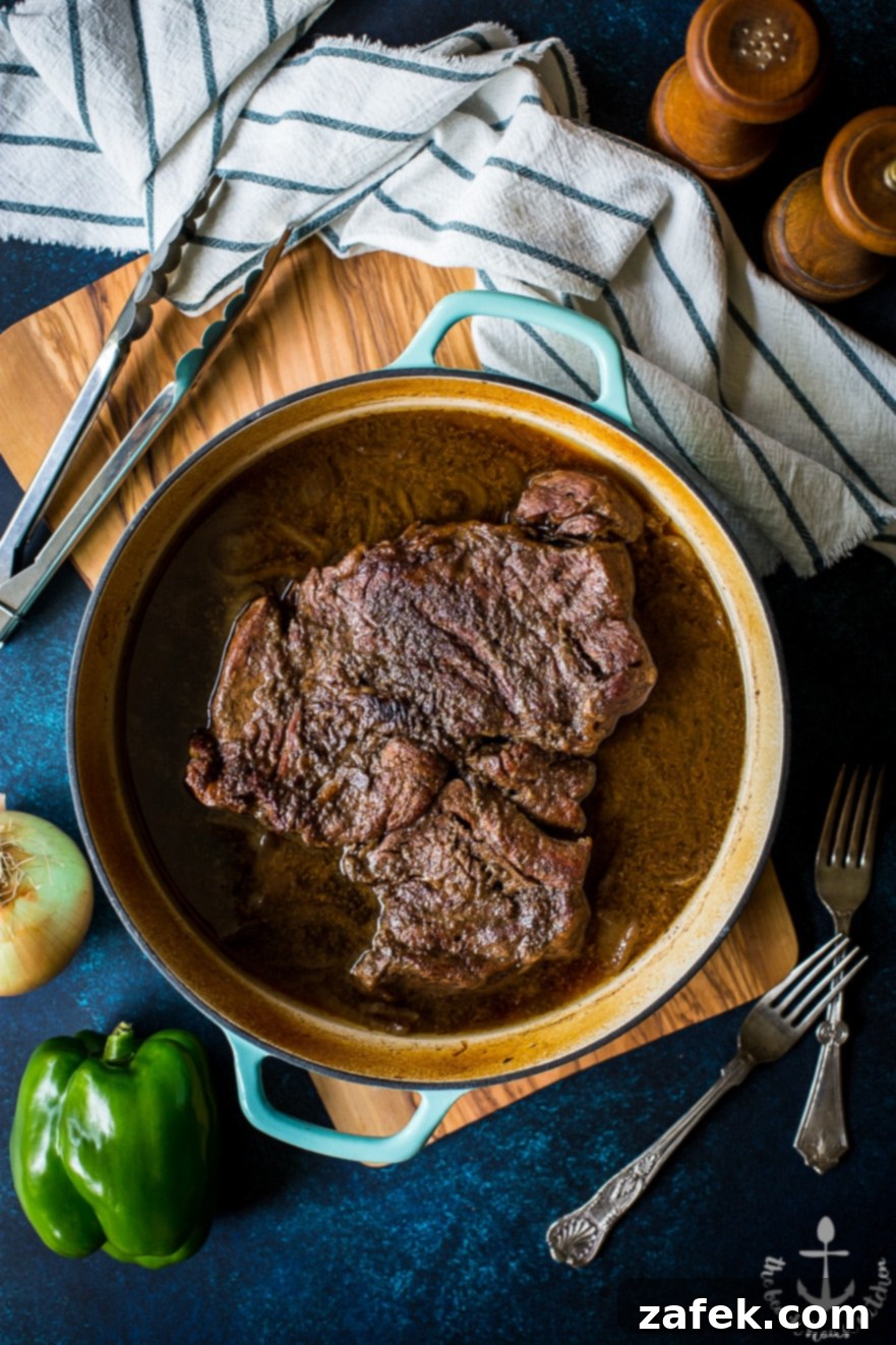 Shredded Roast Beef for French Dip Sandwiches Tender, shredded roast beef simmering in rich au jus, a key component for the ultimate French Dip Sandwiches.