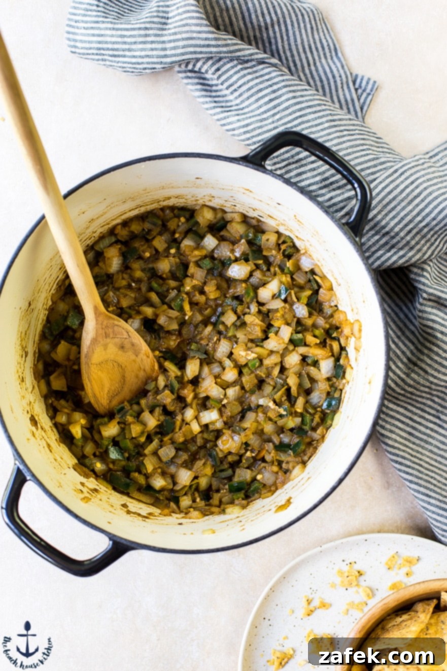 A pot filled with cooked onions and peppers