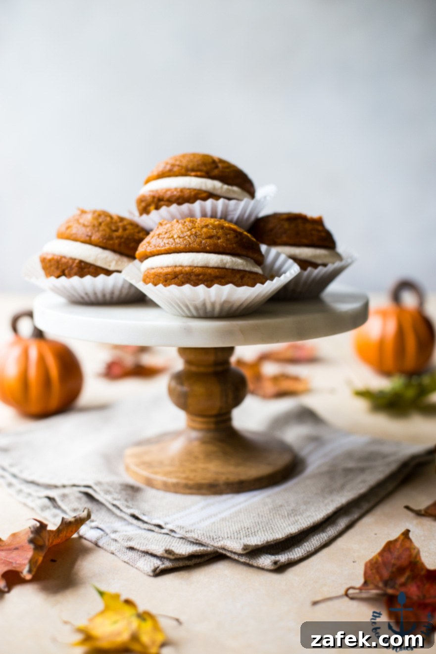 Pumpkin Whoopie Pies with Maple Buttercream Pumpkin Whoopie Pies with Maple Buttercream on a marble cake stand