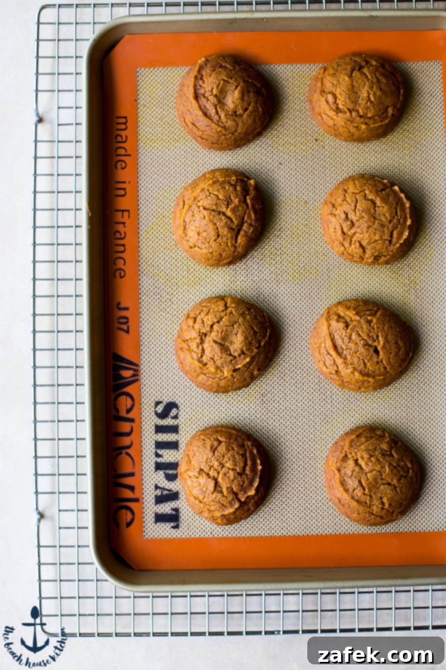 Pumpkin Whoopie Pies with Maple Buttercream Overhead photo of pumpkin whoopie pie cakes on a silpat mat on a wire rack