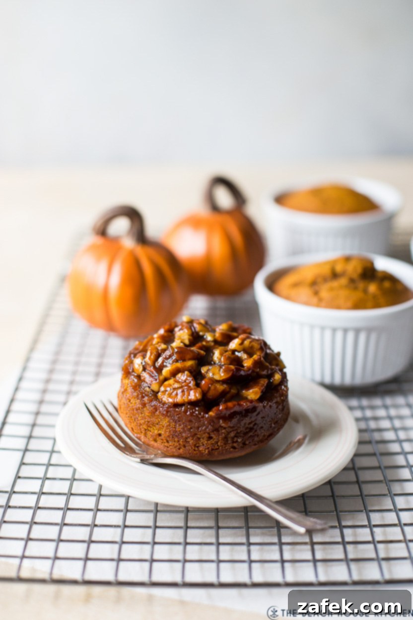 A mini pumpkin praline Upside Down Cake on a plate with a fork