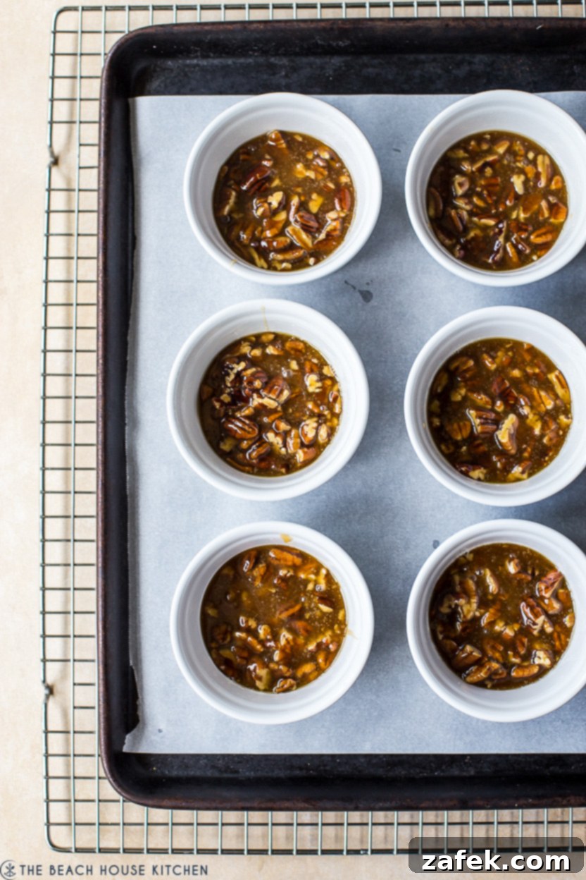 Overhead photo of six ramekins filled with a praline mixture
