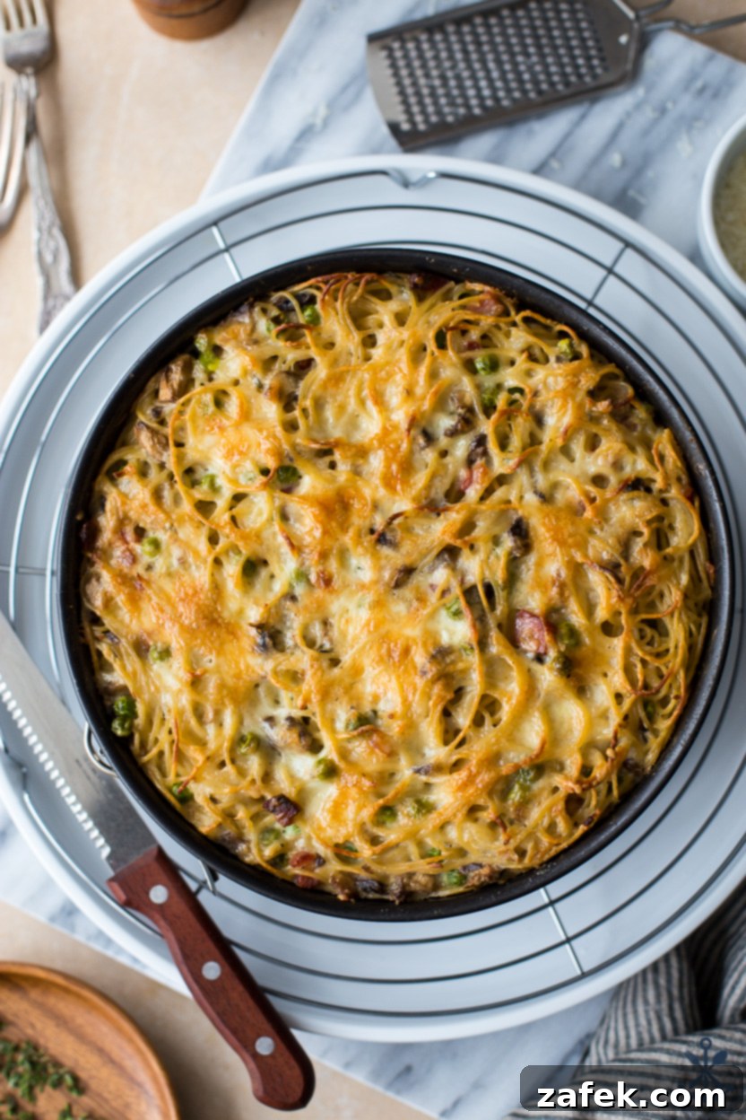 Hearty Pancetta, Mushroom & Pea Spaghetti Pie 4 An overhead shot of the delectable Spaghetti Pie, highlighting its rich, cheesy texture and visible ingredients