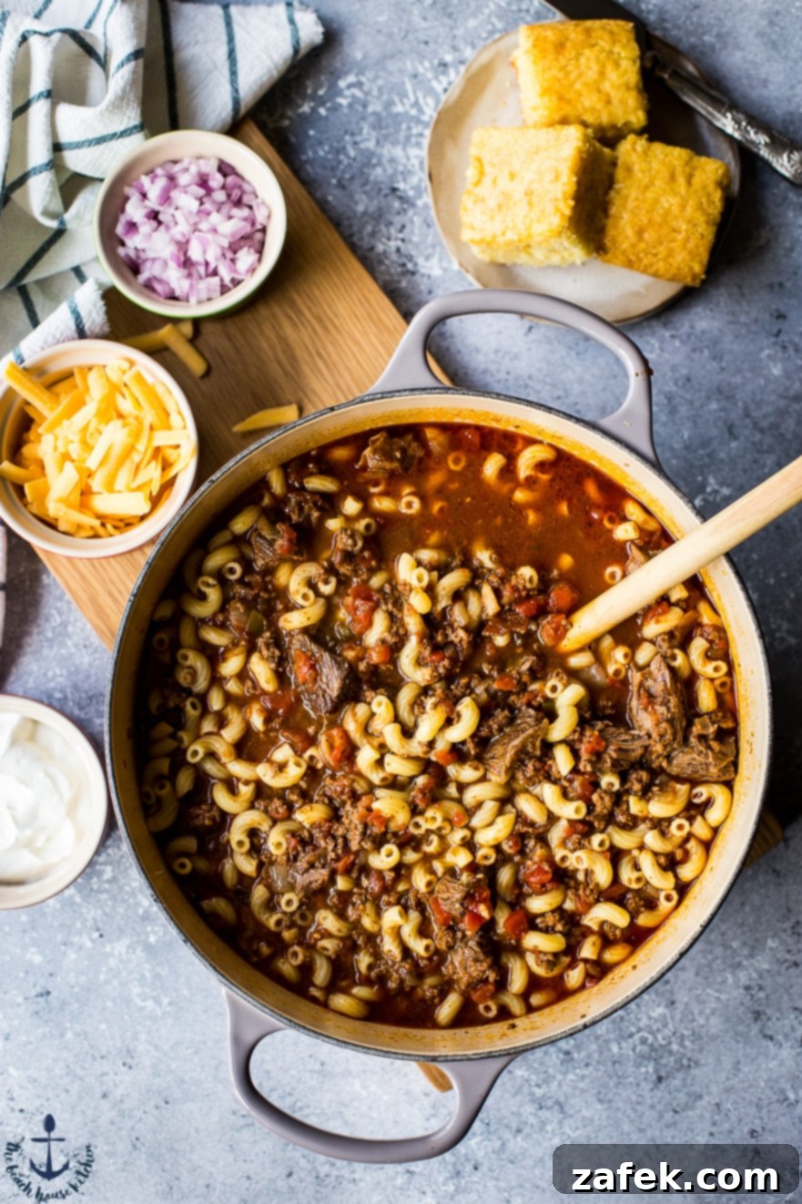 Hearty Chili Mac Pot Uncle John's Chili Mac simmering in a Dutch oven, showing rich color and texture.