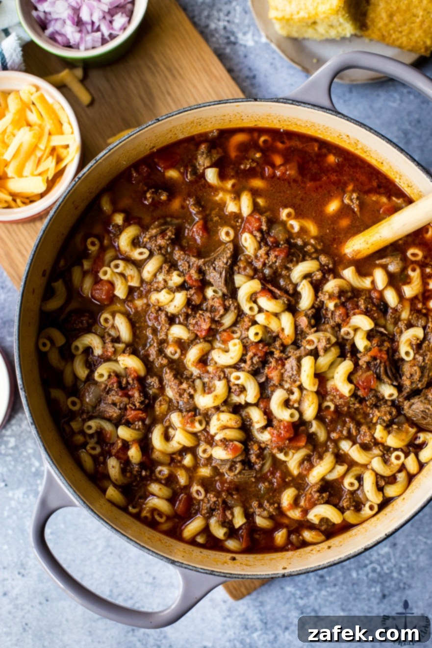 Garnished Chili Mac Bowl Uncle John's Chili Mac served in a bowl, garnished with shredded cheese and fresh herbs.