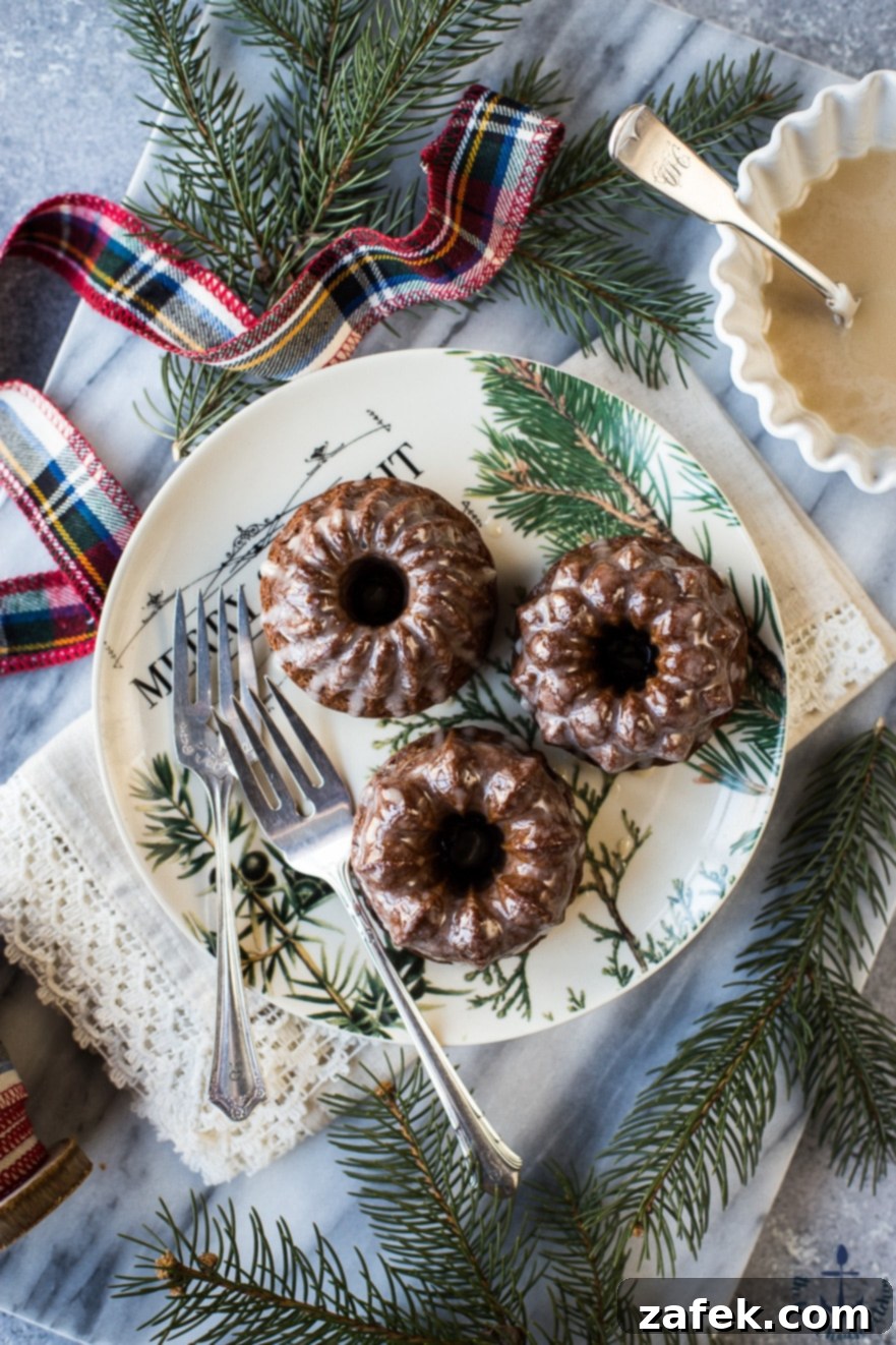 Mini Gingerbread Bundt Cakes with Maple Glaze, featuring rich brown cakes with white glaze on a festive background
