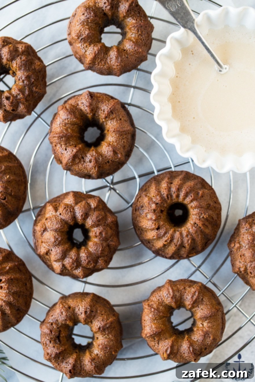 Close-up showing the texture of Mini Gingerbread Bundt Cakes and the glossy maple glaze