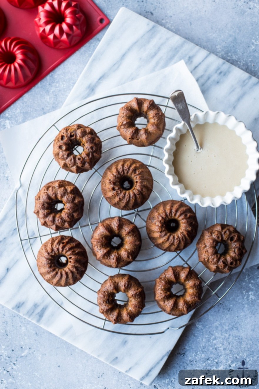 Artfully arranged Mini Gingerbread Bundt Cakes with Maple Glaze, ready to be served