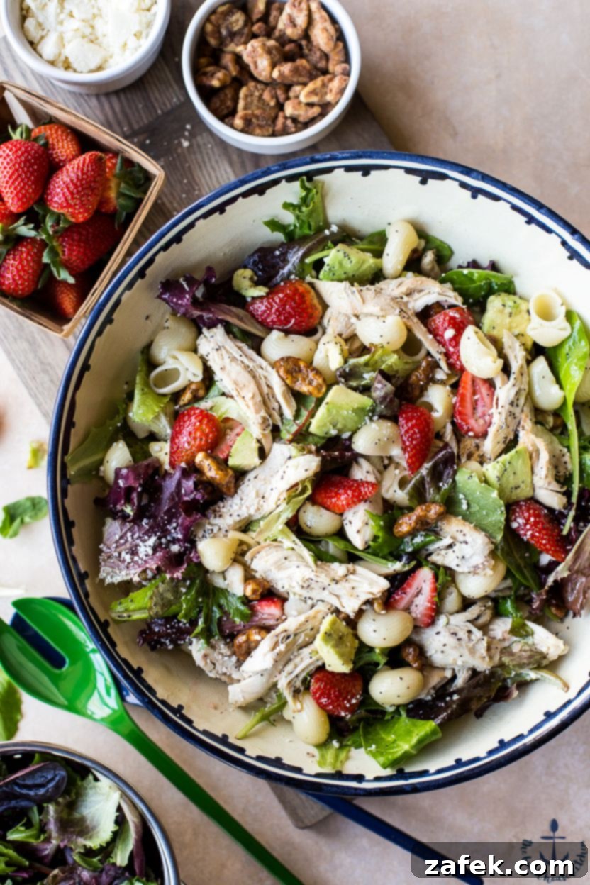 Close-up of the fresh ingredients for Chicken Strawberry Avocado Pasta Salad: vibrant strawberries, creamy avocado, and tender chicken.