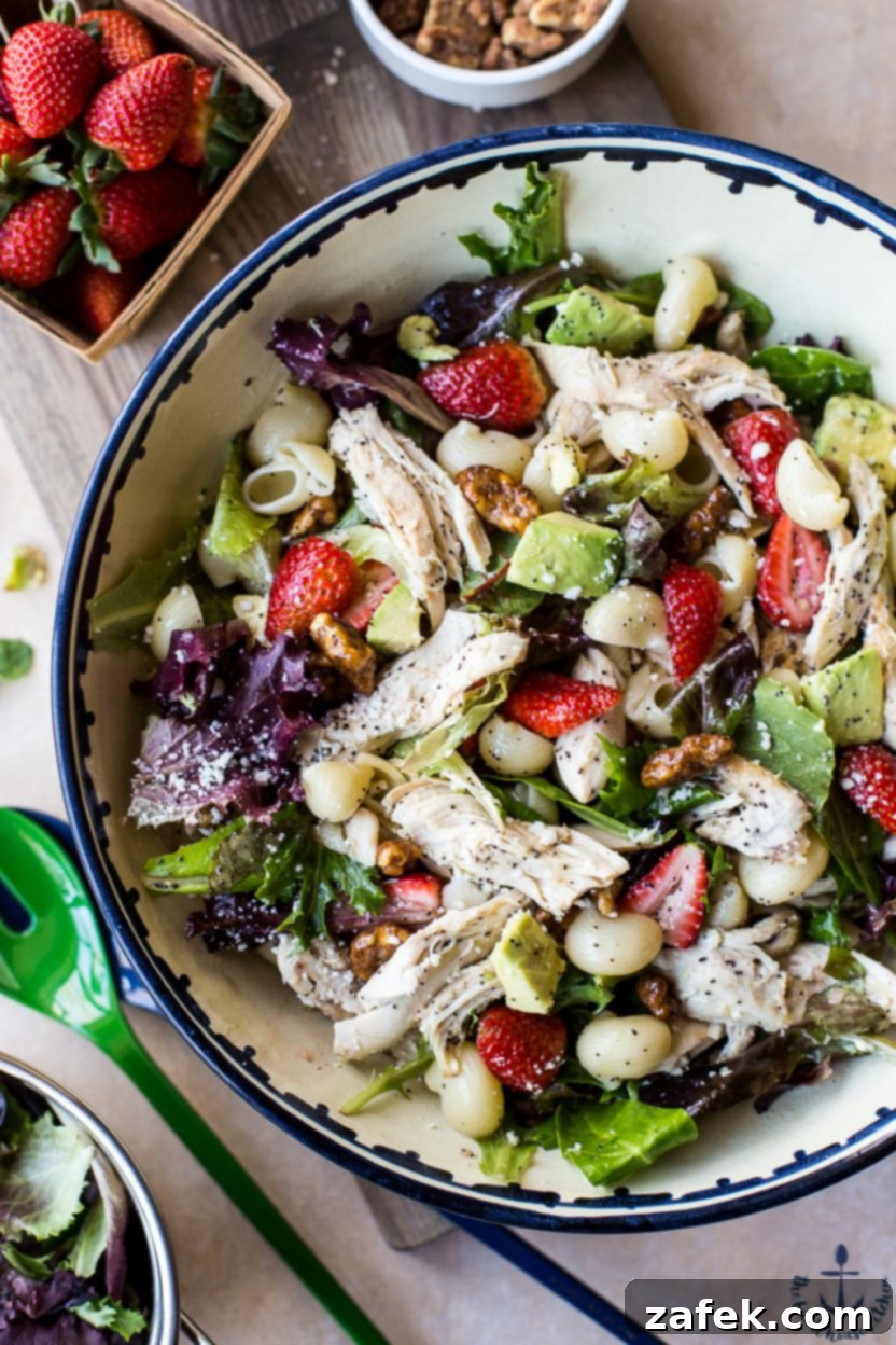A serving of Chicken Strawberry Avocado Pasta Salad, showcasing the vibrant colors and appealing texture, ready to be eaten.