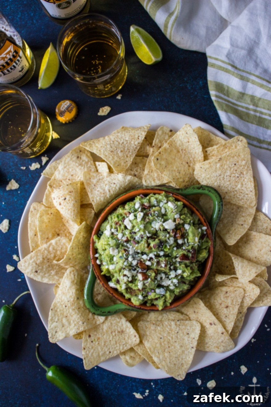 Unique Bacon and Fig Guacamole served in a bowl with tortilla chips