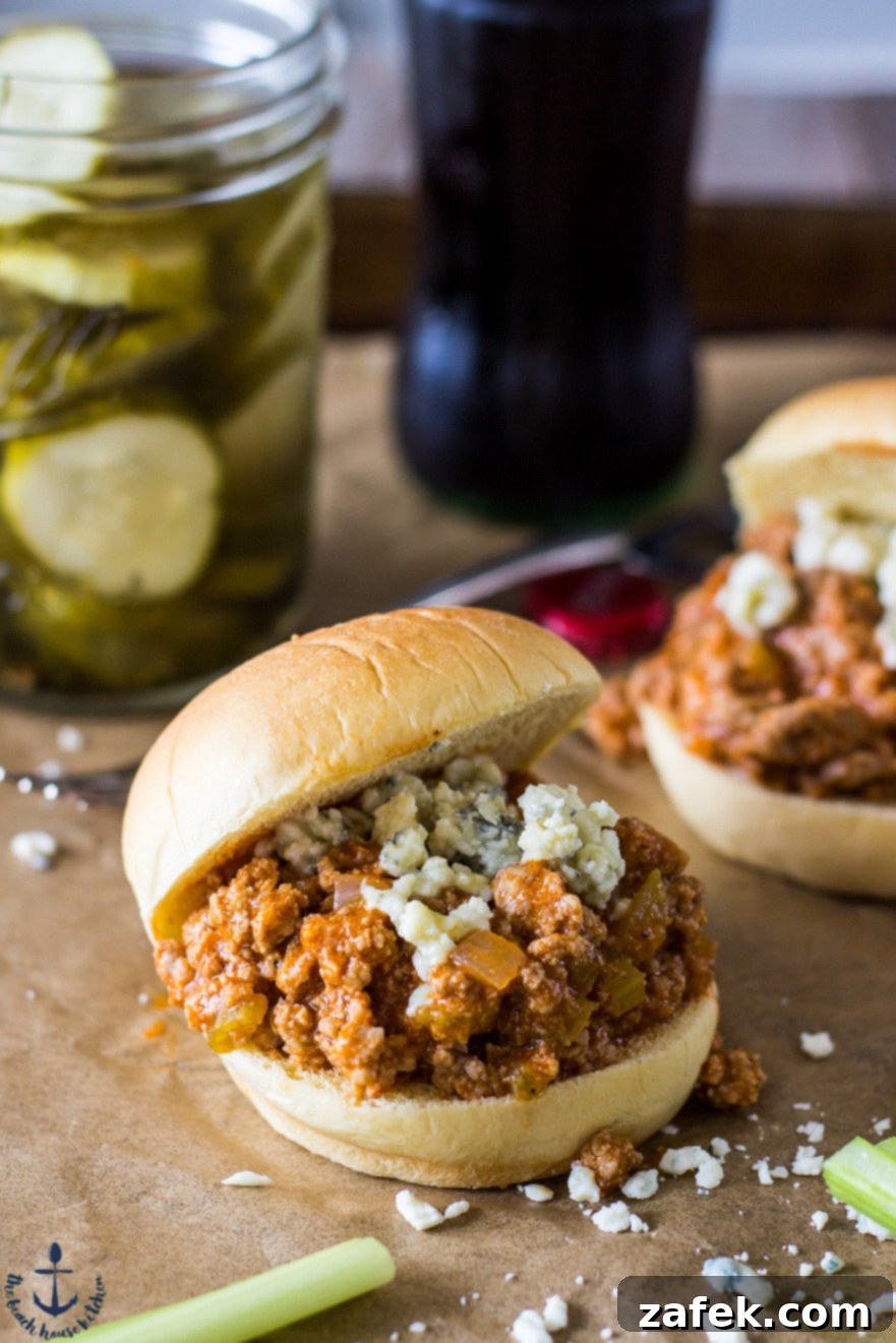 Spicy Buffalo Sloppy Joes served on buns with celery sticks