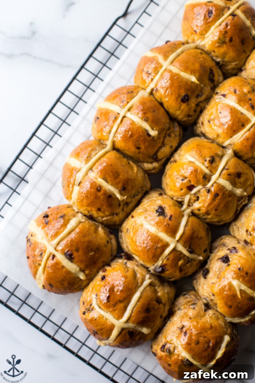 Spiced Easter Buns 4 An inviting overhead shot of delicious Hot Cross Buns arranged perfectly on a wire cooling rack.