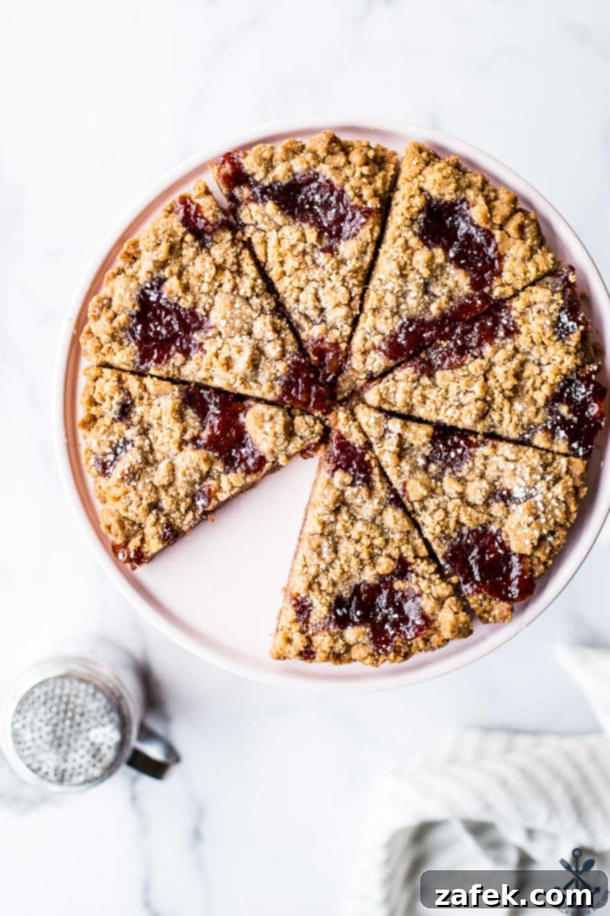 Overhead photo of wedges of jam cookies on a cake pedestal