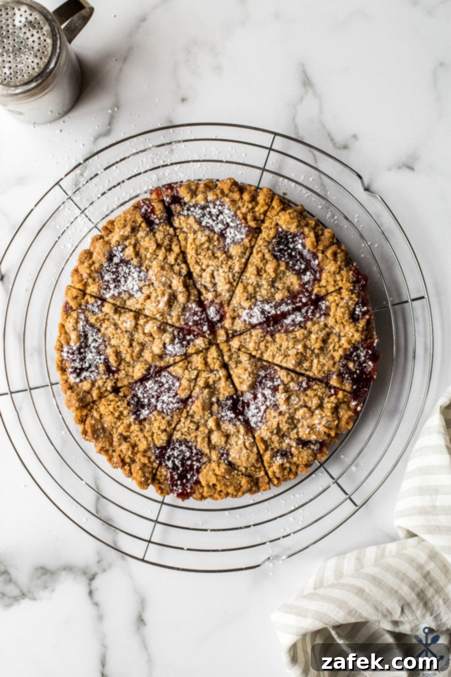 Overhead photo ofwedges of jam crumb cookies on a round wire rack