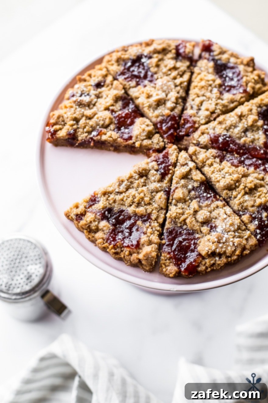 Weddges of crumb cookies on a pale pink cake pedestal