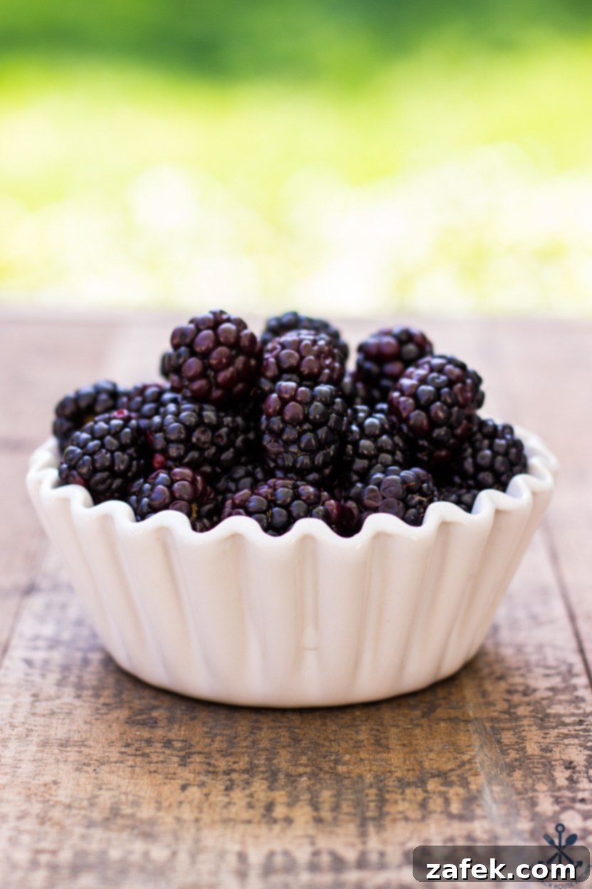 Elegant Blackberry Almond Bites 3 A bowl of fresh, ripe blackberries, ready to be incorporated into the financiers